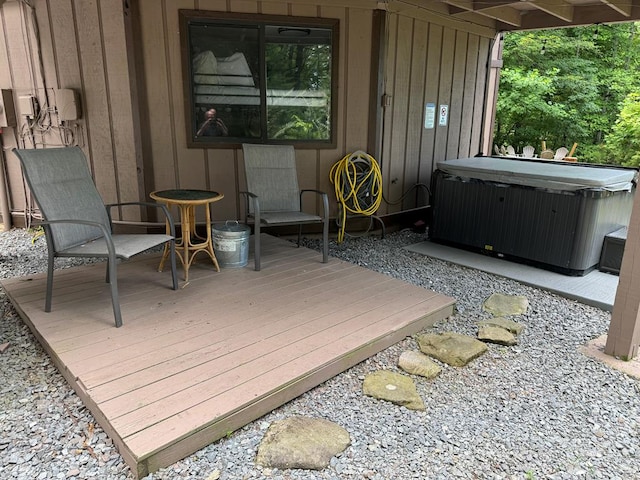 wooden deck featuring a hot tub