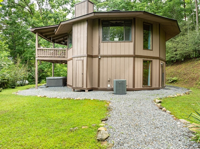 view of outdoor structure with central AC and a lawn