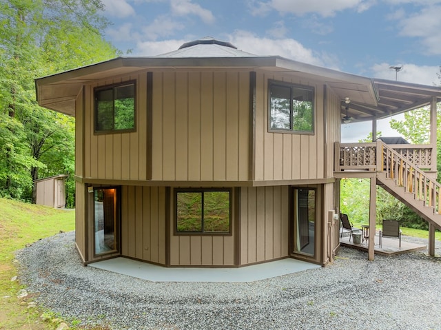 exterior space with a deck, a patio, and stairway