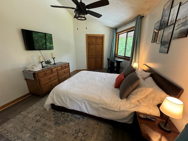 bedroom with lofted ceiling, a textured ceiling, hardwood / wood-style floors, and ceiling fan