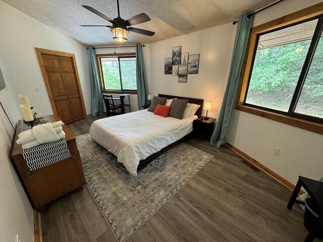 living room with wood walls, wood-type flooring, and plenty of natural light