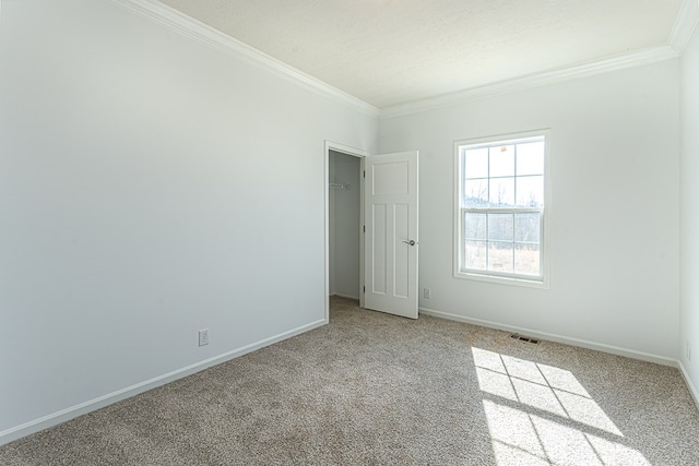 spare room with crown molding and light carpet