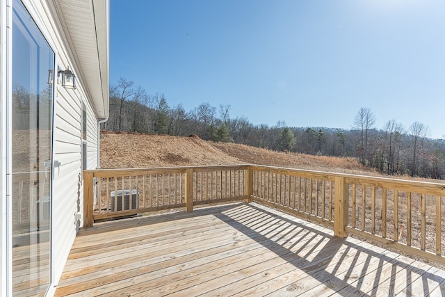 wooden terrace featuring central AC unit