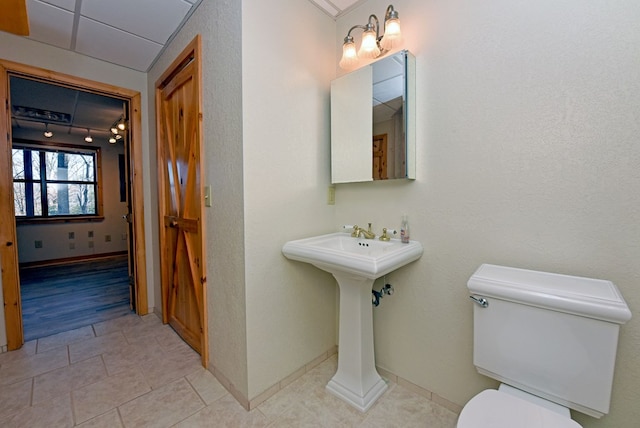 bathroom with tile patterned floors and toilet