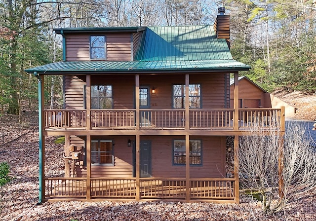 rear view of property featuring a balcony