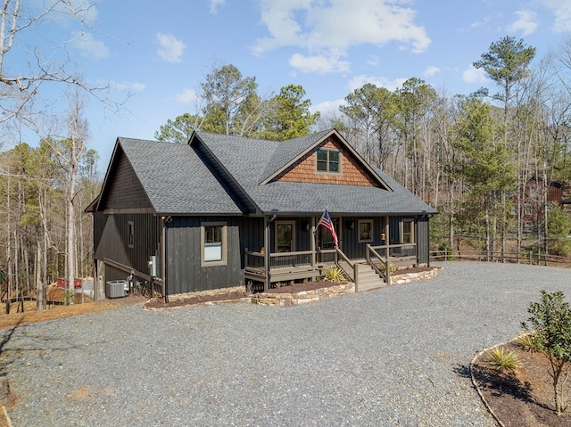 rustic home featuring fence, central AC unit, driveway, covered porch, and a shingled roof