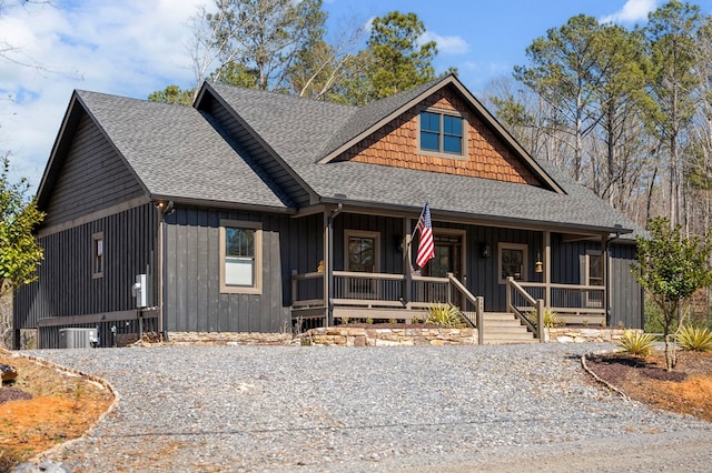 view of front of home featuring board and batten siding, covered porch, and a shingled roof