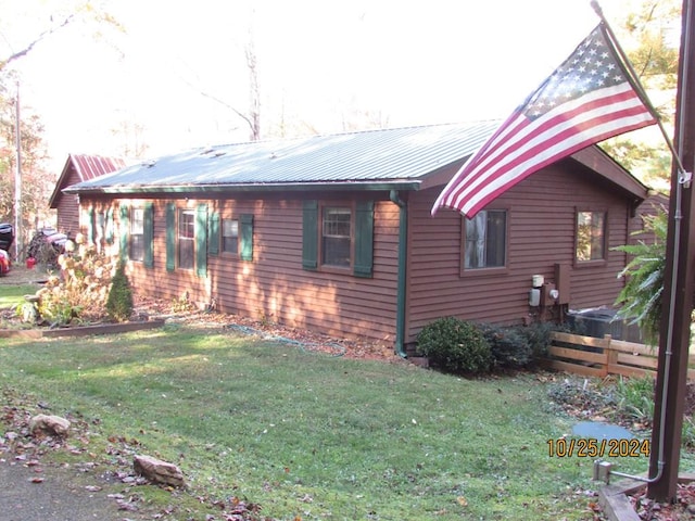 view of property exterior featuring a lawn