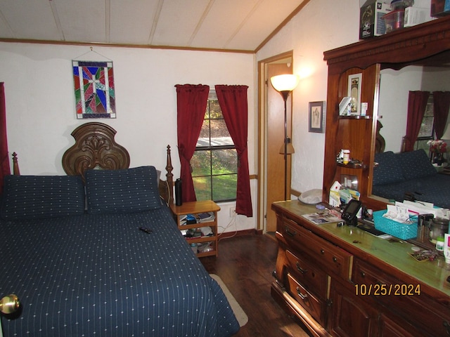 bedroom featuring lofted ceiling, crown molding, and dark hardwood / wood-style flooring