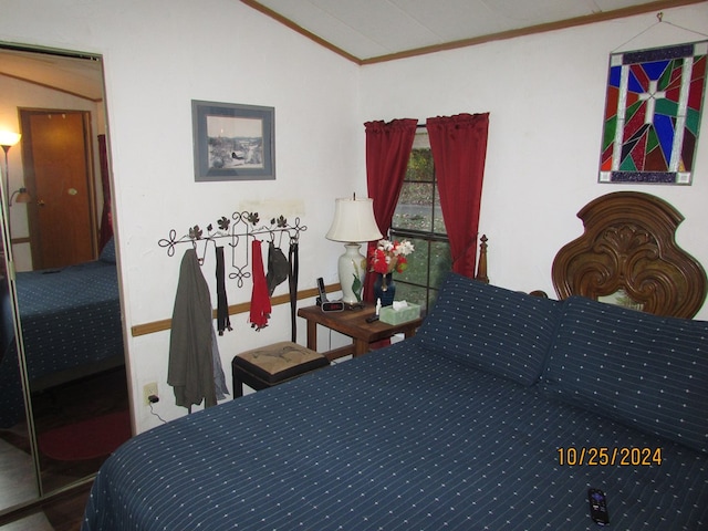 bedroom featuring ornamental molding and vaulted ceiling