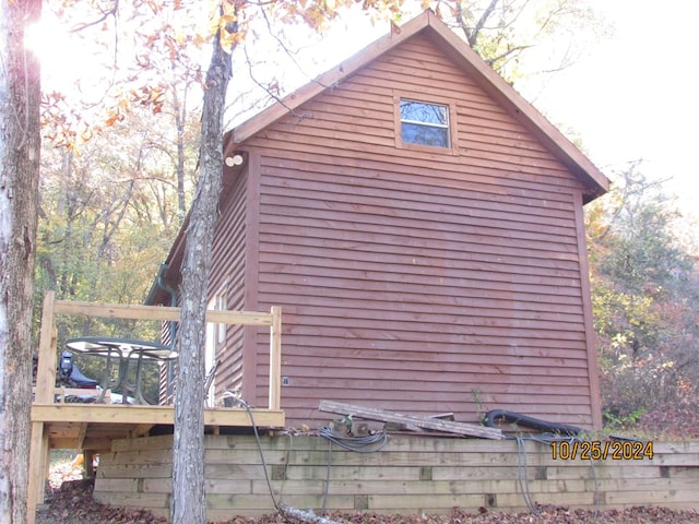 view of property exterior with a wooden deck