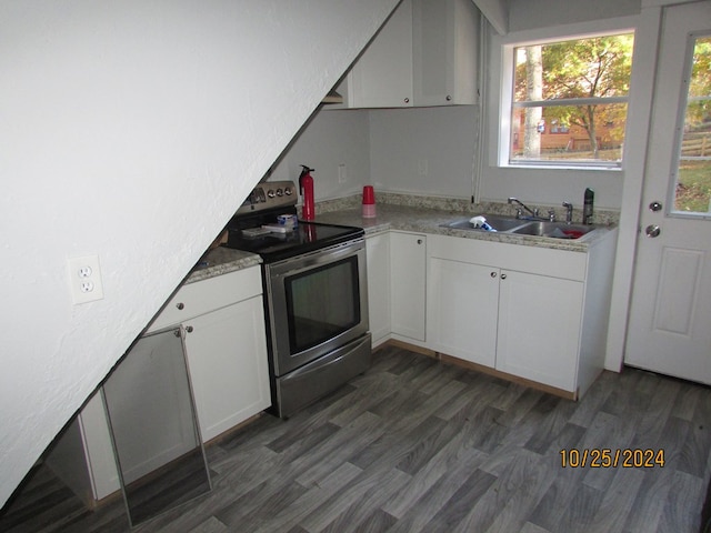 kitchen featuring stainless steel electric stove, white cabinets, sink, and dark hardwood / wood-style floors