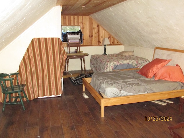 bedroom featuring dark wood-type flooring, wood walls, and vaulted ceiling