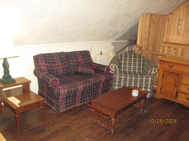 interior space with wooden walls, vaulted ceiling, and dark hardwood / wood-style flooring