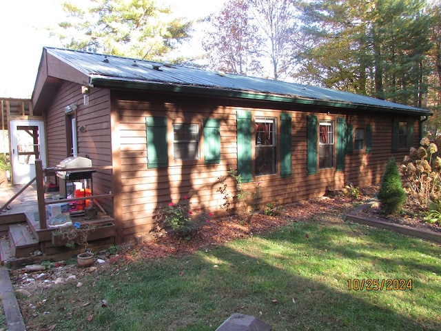 view of home's exterior with a yard