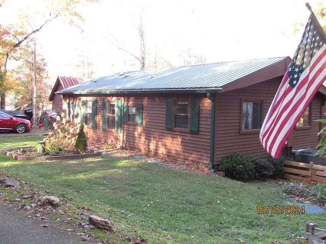 view of side of home featuring a yard