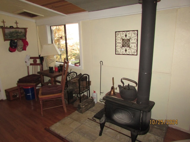 interior space with a wood stove and wood-type flooring