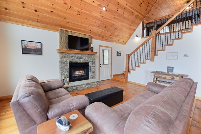 living area with stairs, wood finished floors, wood ceiling, and baseboards