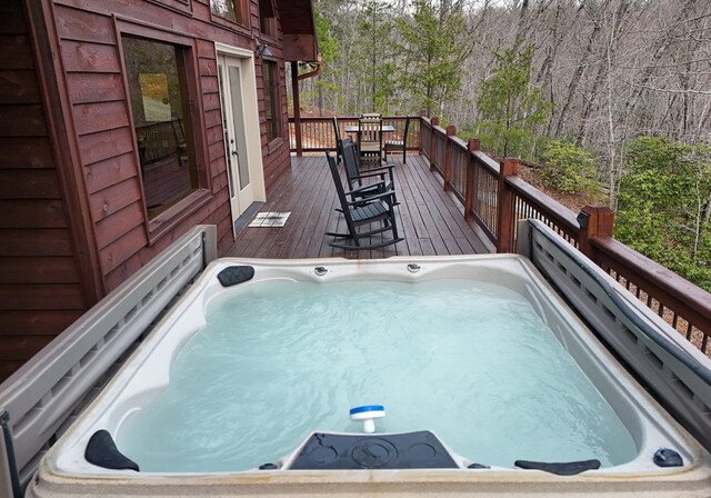 view of swimming pool featuring a covered hot tub and a wooden deck