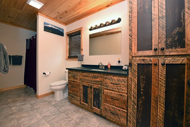 bathroom featuring toilet, vanity, wood ceiling, and baseboards