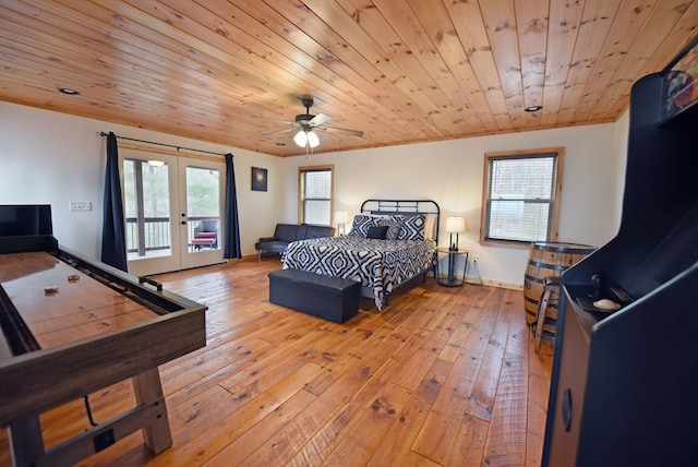 bedroom with light wood finished floors, access to outside, french doors, and multiple windows