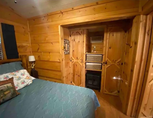 bedroom featuring wooden walls