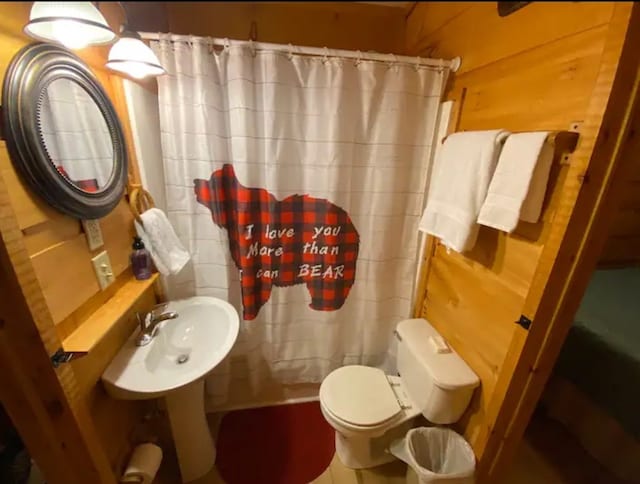 bathroom featuring sink, a shower with curtain, and toilet