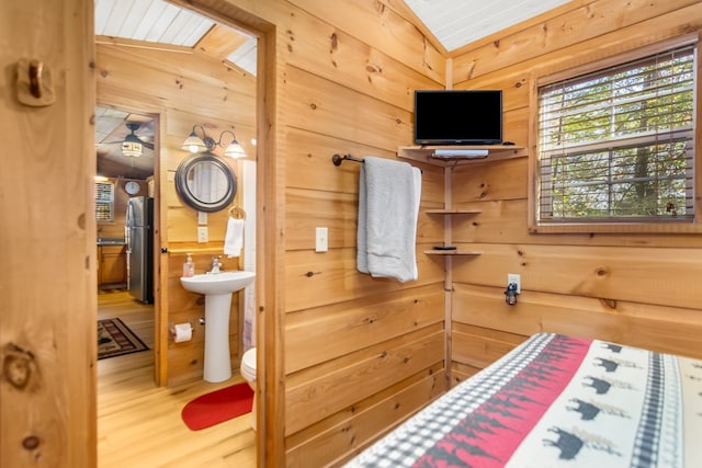 bathroom featuring wood ceiling, toilet, vaulted ceiling, wooden walls, and hardwood / wood-style flooring