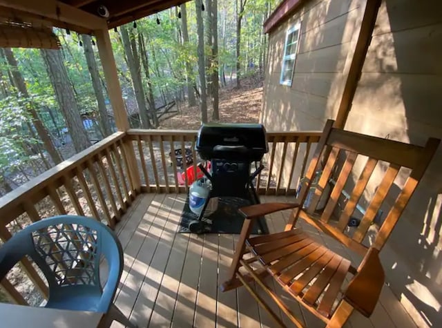 wooden deck with a grill