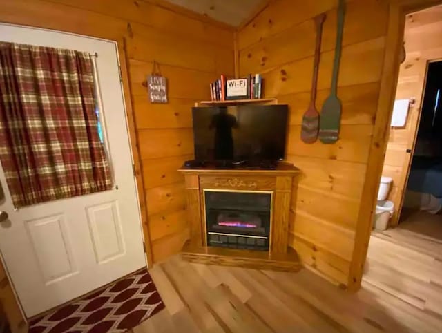 interior space with wood walls and wood-type flooring