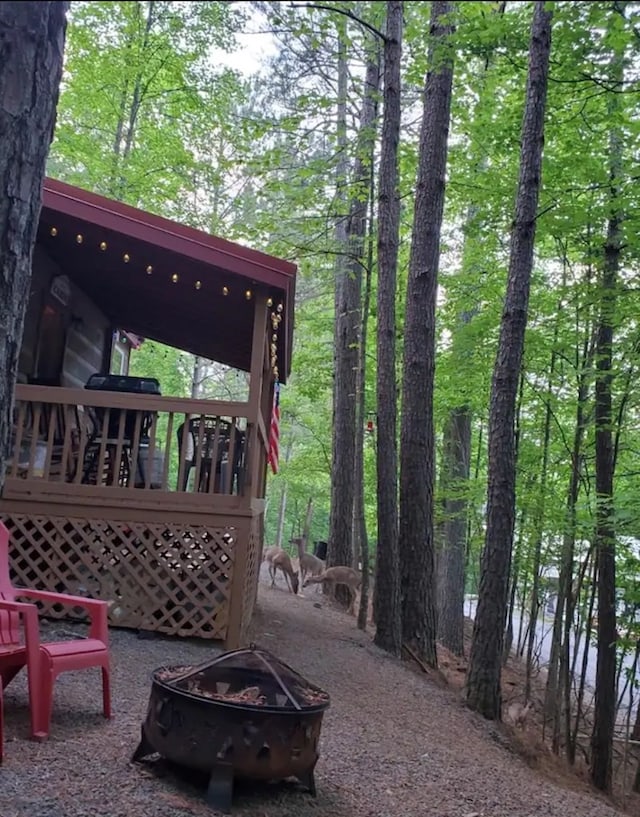 view of patio / terrace featuring an outdoor fire pit and a deck