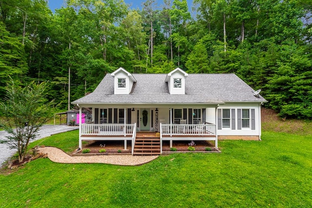 cape cod house with covered porch, a front lawn, and roof with shingles