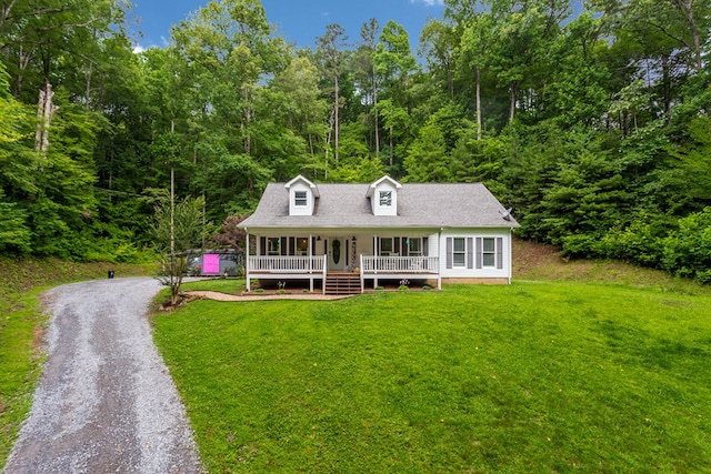 cape cod house with a porch, a front yard, gravel driveway, and a shingled roof