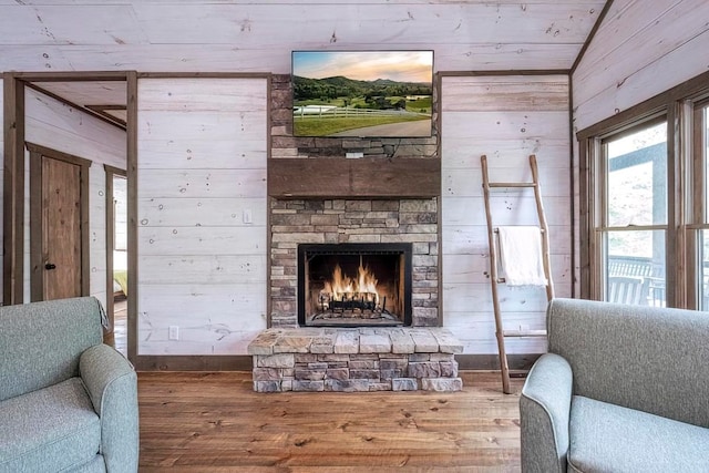 1085 Dills Rd, Blue Ridge, GA 30513 - living area with wooden walls, wood finished floors, a fireplace, and baseboards