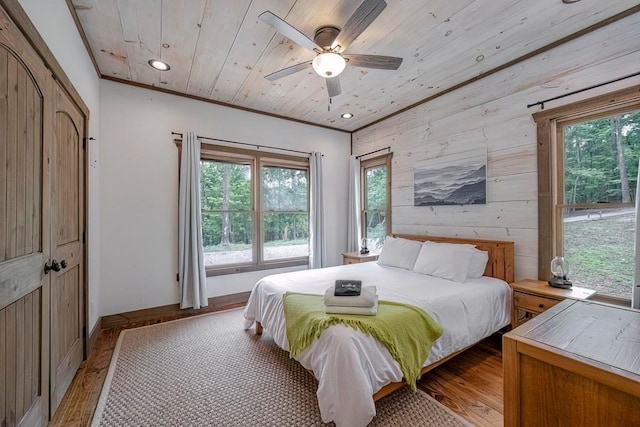 1085 Dills Rd, Blue Ridge, GA 30513 - bedroom featuring multiple windows, light wood-style flooring, wooden walls, wooden ceiling, and a ceiling fan