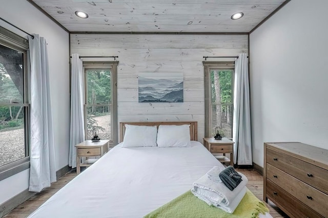 1085 Dills Rd, Blue Ridge, GA 30513 - bedroom with wooden walls, wood finished floors, multiple windows, recessed lighting, and baseboards