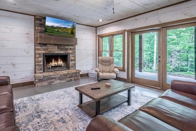1085 Dills Rd, Blue Ridge, GA 30513 - living area with concrete flooring, wood ceiling, plenty of natural light, a fireplace, and wooden walls