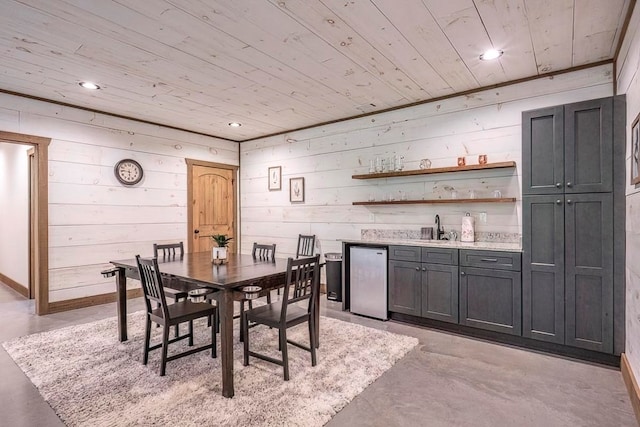 1085 Dills Rd, Blue Ridge, GA 30513 - dining space with wood ceiling, bar with sink, finished concrete flooring, wood walls, and recessed lighting