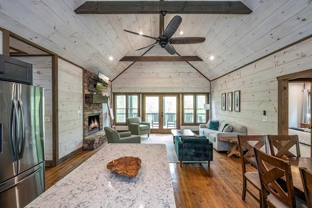 1085 Dills Rd, Blue Ridge, GA 30513 - living room with wooden walls, wooden ceiling, a stone fireplace, dark wood-style floors, and beamed ceiling