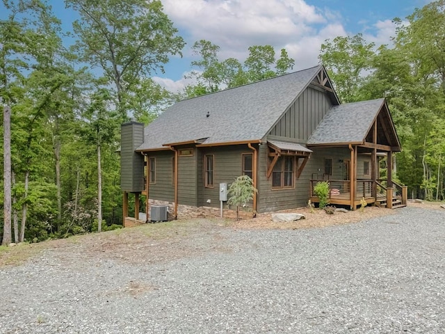 1085 Dills Rd, Blue Ridge, GA 30513 - view of front of property featuring board and batten siding, a chimney, gravel driveway, covered porch, and a shingled roof