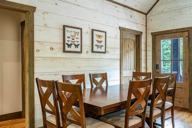 1085 Dills Rd, Blue Ridge, GA 30513 - dining room featuring wood walls, light wood-style floors, and lofted ceiling