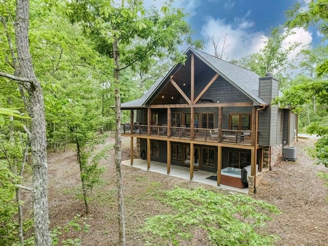 1085 Dills Rd, Blue Ridge, GA 30513 - rear view of property with cooling unit, a chimney, a patio, a deck, and a hot tub