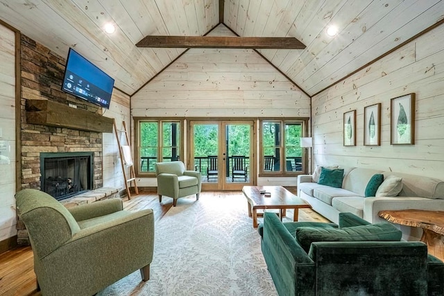 1085 Dills Rd, Blue Ridge, GA 30513 - living area with wood-type flooring, wood ceiling, wood walls, a stone fireplace, and high vaulted ceiling