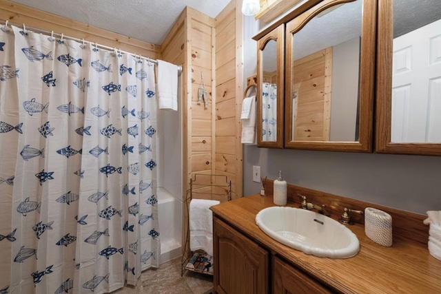 bathroom with vanity, a shower with curtain, and a textured ceiling