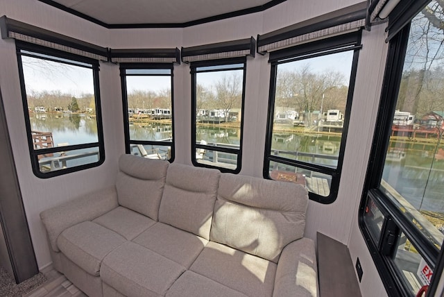 interior space featuring a water view, plenty of natural light, and wood finished floors