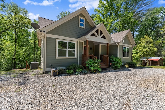 457 Celie Ann Seabolt Rd, Cleveland, GA 30528 - view of front facade with a shingled roof, cooling unit, covered porch, and an outbuilding