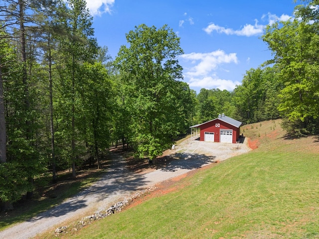 457 Celie Ann Seabolt Rd, Cleveland, GA 30528 - view of front of property with driveway, a front yard, a detached garage, a forest view, and an outdoor structure