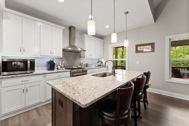 457 Celie Ann Seabolt Rd, Cleveland, GA 30528 - kitchen with a sink, wall chimney range hood, stainless steel appliances, decorative backsplash, and an island with sink