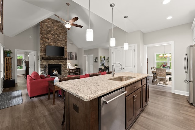 457 Celie Ann Seabolt Rd, Cleveland, GA 30528 - kitchen with a sink, stainless steel appliances, wood finished floors, dark brown cabinets, and a stone fireplace