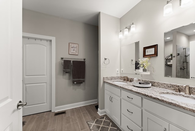 457 Celie Ann Seabolt Rd, Cleveland, GA 30528 - full bathroom featuring a tile shower, wood finished floors, double vanity, and baseboards